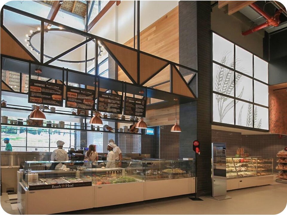 Grocery deli counter with architectural trusses and wheat glass art