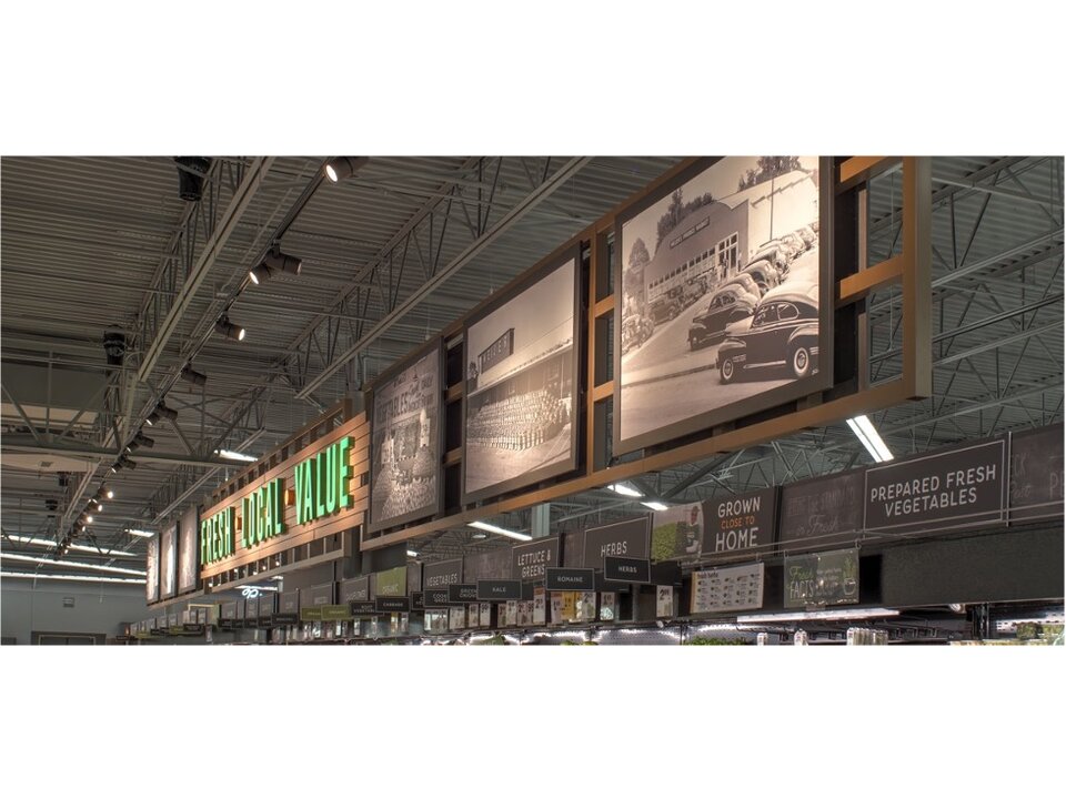 Grocery ceiling-hung photo gallery and Fresh Local Value signage